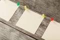 Sticky notes with pins in a row on a wooden background Royalty Free Stock Photo