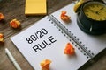 Sticky notes,trash paper,clock pen and notebook written with 80/20 Rule on wooden background Royalty Free Stock Photo
