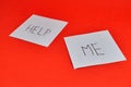 Sticky notes with the words HELP and ME viewed at an angle, highlighting a plea for aid and a call to respond. Royalty Free Stock Photo