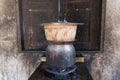 Sticky rice being cooked in dirty old kitchen.