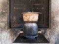 Sticky rice being cooked in dirty old kitchen.