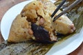 Sticky rice steam with pork and salt egg in banana leaf of Chinese Duanwu festival