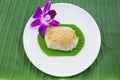 Sticky rice with steamed custard on banana leaves and dish with orchid flower Royalty Free Stock Photo