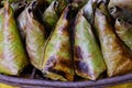 Sticky rice wrapped with banana leaf and banana grilling on stove Royalty Free Stock Photo