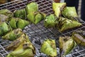 Sticky rice wrapped in banana leaves, roasted on the grill is a popular food in Thailand Royalty Free Stock Photo