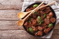 Stifado beef with sauce and basil close up in a dish. Horizontal