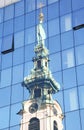 Stiftskirche in reflections of high glass building