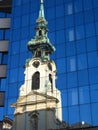 Stiftskirche in Vienna reflecting in opposite glass facade, Austria