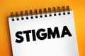 Stigma - a mark of disgrace associated with a particular circumstance, quality, or person, text concept on notepad