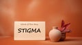 Stigma and shame concept. Word stigma written on a paper card, minimalist background
