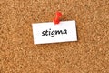 Stigma. Word written on a piece of paper, cork board background