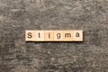 stigma word written on wood block. stigma text on table, concept