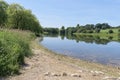 Still water of Staunton Harold Reservoir on a summer day