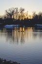 A cold calm city park lake in the cold winter sunlight Royalty Free Stock Photo