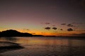 Vibrant colorful sunrise on the beach. Light reflections on water and sky