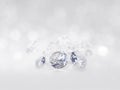 still with expensive cut diamonds in front of a white background, reflections on the ground. Lot of copy space Royalty Free Stock Photo