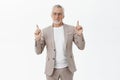 Still hanging on top. Portrait of charming kind and friendly happy relaxed senior businessman in formal elegant suit and Royalty Free Stock Photo