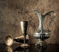 Still life with Ancient jug for wine and silver goblets Royalty Free Stock Photo