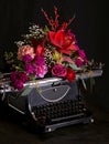 Still life - antique printing press and bright flowers on a dark background Royalty Free Stock Photo