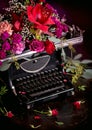 Still life - antique printing press and bright flowers on a dark background Royalty Free Stock Photo