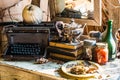 Still life, antique typewriter, old books, silver tea pot, glass jars