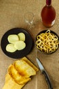 Still life with appetizer with toast, cheese, savory and rose wine