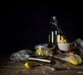 Still life with apples, apple juice, old books and a silver knife on a wooden table on a dark background. vintage Royalty Free Stock Photo