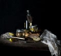 Still life with apples, apple juice, old books and a silver knife on a wooden table on a dark background. vintage Royalty Free Stock Photo