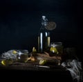 Still life with apples, apple juice, old books and a silver knife on a wooden table on a dark background. vintage Royalty Free Stock Photo