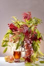 Still life with apples, a glass of Apple juice and Rowan branches. The vertical frame Royalty Free Stock Photo