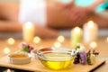 Still life of aromatic Ayurvedic massage oils with therapist in