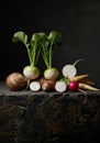 Still Life of Assorted Root Vegetables on Dark Surface Royalty Free Stock Photo