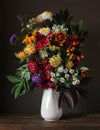 Still life with asters and chrysanthemums in a white jug. Royalty Free Stock Photo