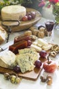 Still-life of Asturian blue cheese cabrales with sweet quince, nuts, hazelnuts, grapes, apple, and red wine