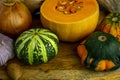 Still life with autumn vegetables and fruits on wooden background. Pumpkins, butternut, garlic