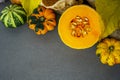 Still life with autumn vegetables and fruits on wooden background. Pumpkins, butternut, garlic, bow