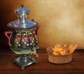 Still life: a beautiful samovar on the table, and a wicker basket of bread.