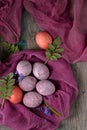 Still life of beautiful textured purple eggs on purple gauze Royalty Free Stock Photo