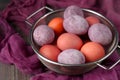Still life of beautiful textured purple eggs in the sieve Royalty Free Stock Photo
