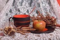 Still-life with big mug, apple and dried herbs