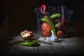 Still life on a black background. Red pepper, pumpkin, chilli pepper and garlic. Pepper halves lying on a chopping board Royalty Free Stock Photo