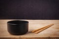 Still life black bowl with wooden shopsticks