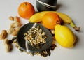 Still life - black bowls with fresh fruit and various seeds