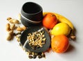 Still life - black bowls with fresh fruit and seeds