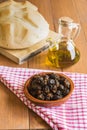 Still life with black olives, extra virgin olive oil and bread