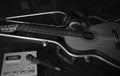Still life in black and white with a guitar in a case and a dynamic microphone with headphones and a drum machine Royalty Free Stock Photo