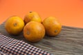 A still life with blood oranges on orange background and a wooden board Royalty Free Stock Photo