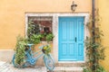 Still life with blue bicycle at door and window of a house. Royalty Free Stock Photo