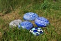 Still life of blue Hand Painted Stones in the Grass, Close-up