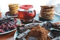 still life on blue plates pancakes with peas, grated chocolate, chocolate bars, brewed tea Royalty Free Stock Photo